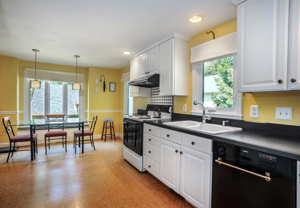 56 Bay Farm Road, Unit 56 Duxbury, MA 02332 - Photo 9 of 20 a kitchen with a sink a stove and cabinets