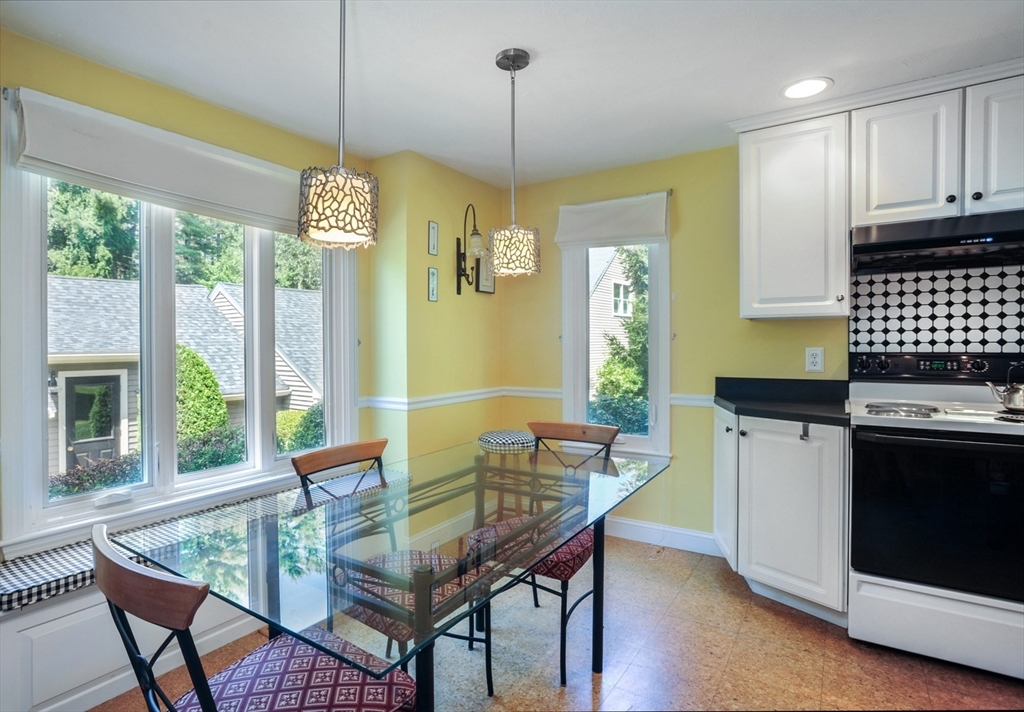 56 Bay Farm Road, Unit 56 Duxbury, MA 02332 - Photo 10 of 20 a dining room with furniture a chandelier and wooden floor