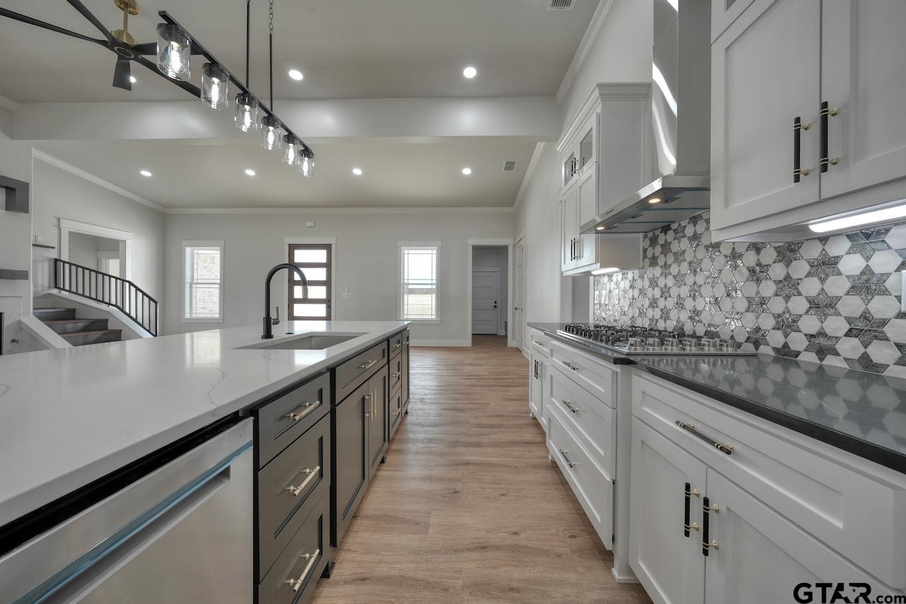 19383 Ridge Point Circle Lindale, TX 75771 - Photo 19 of 48 a large kitchen with stainless steel appliances lots of counter space and window