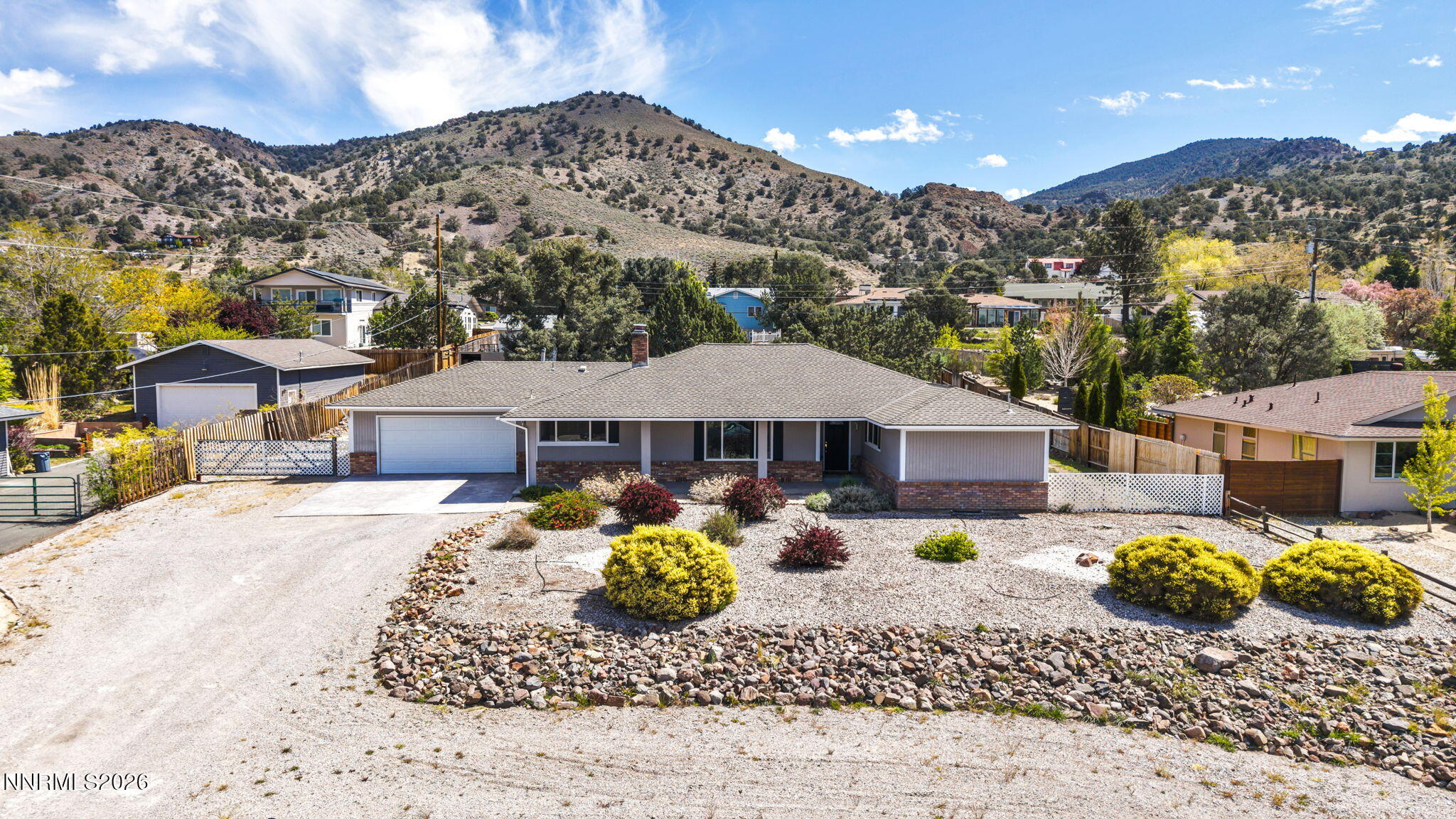 14190 Rim Rock Drive Reno, NV 89521 - Photo 3 of 68 a front view of a house with a yard
