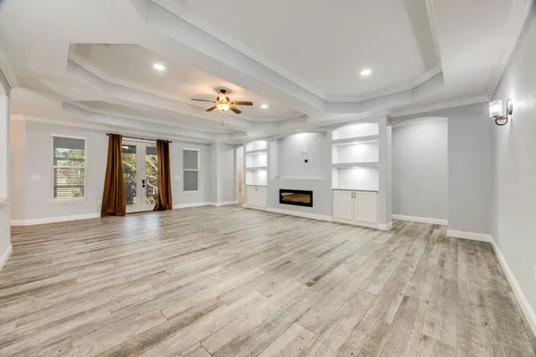a view of a room with wooden floor and windows in a room