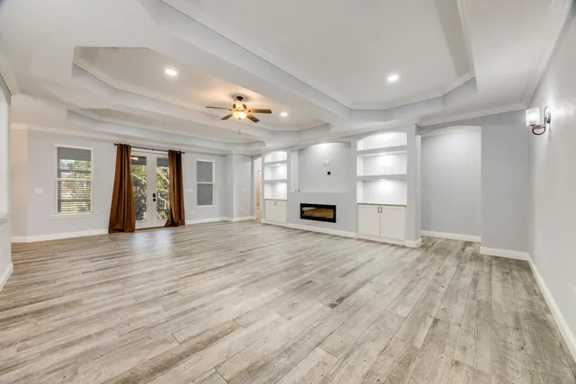 a view of a room with wooden floor and windows in a room