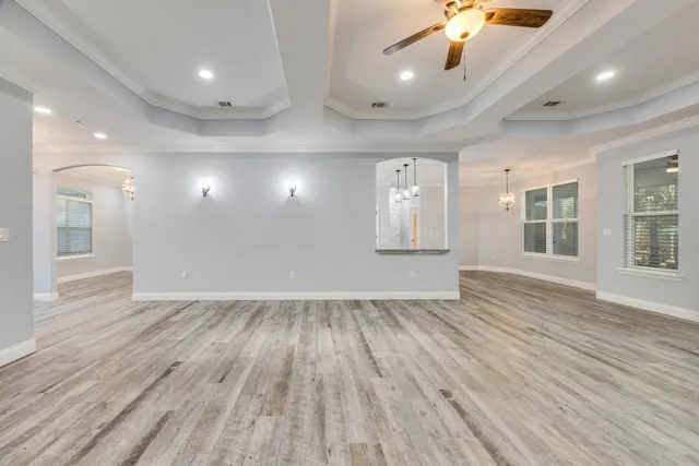 a large kitchen with kitchen island a stove a sink a center island and wooden floor