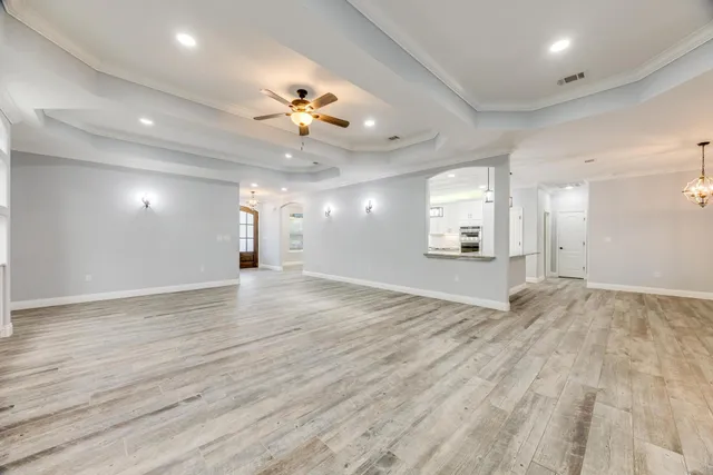 a kitchen with stainless steel appliances granite countertop a sink a refrigerator and a granite counter tops