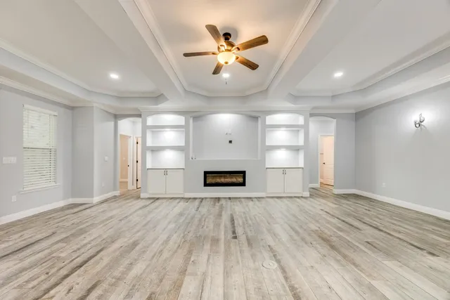 a kitchen with stainless steel appliances granite countertop a stove and a white cabinets