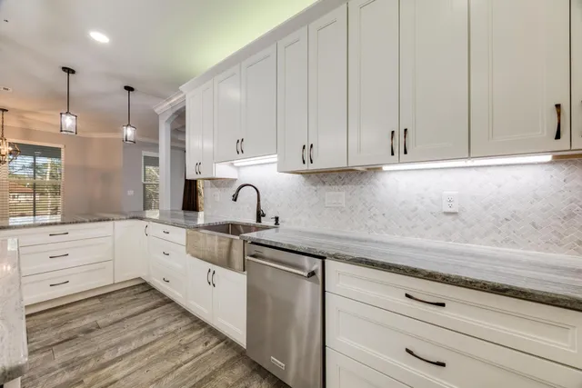a view of an empty room and window a ceiling fan and wooden floor