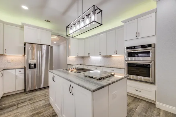 a bathroom with double sink and two mirror