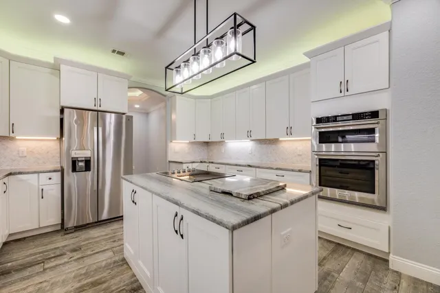 a bathroom with double sink and two mirror