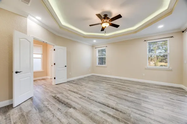 an empty room with a ceiling fan and entryway