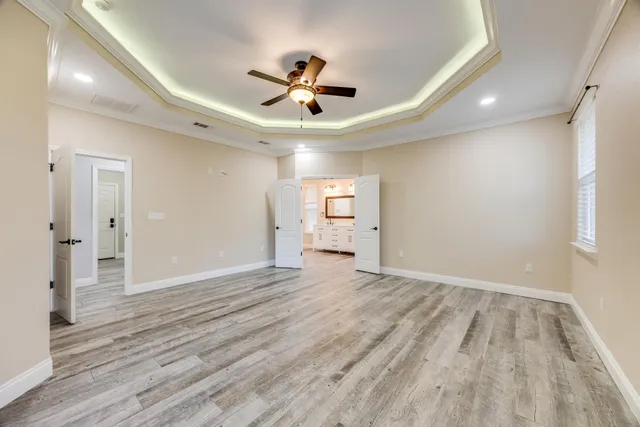 front view of a house with potted plants and a large window