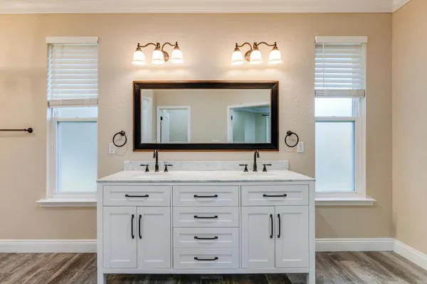 a view of a big house with a big yard and large trees