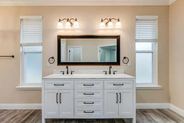 a view of a big house with a big yard and large trees