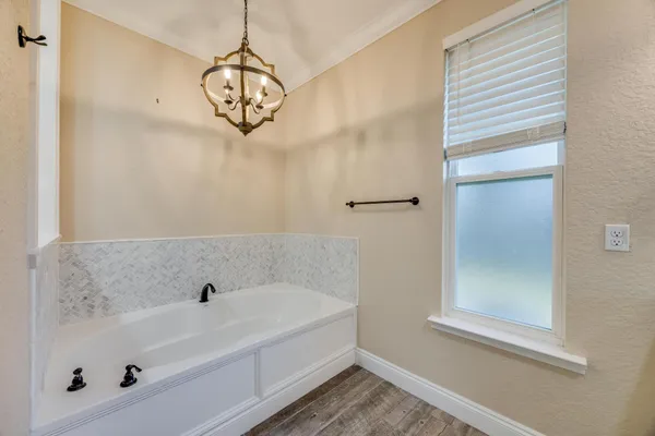 an aerial view of a house with a yard and large tree