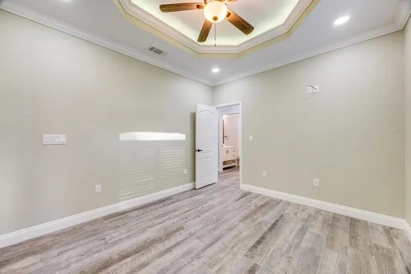 a view of an empty room with window and fireplace