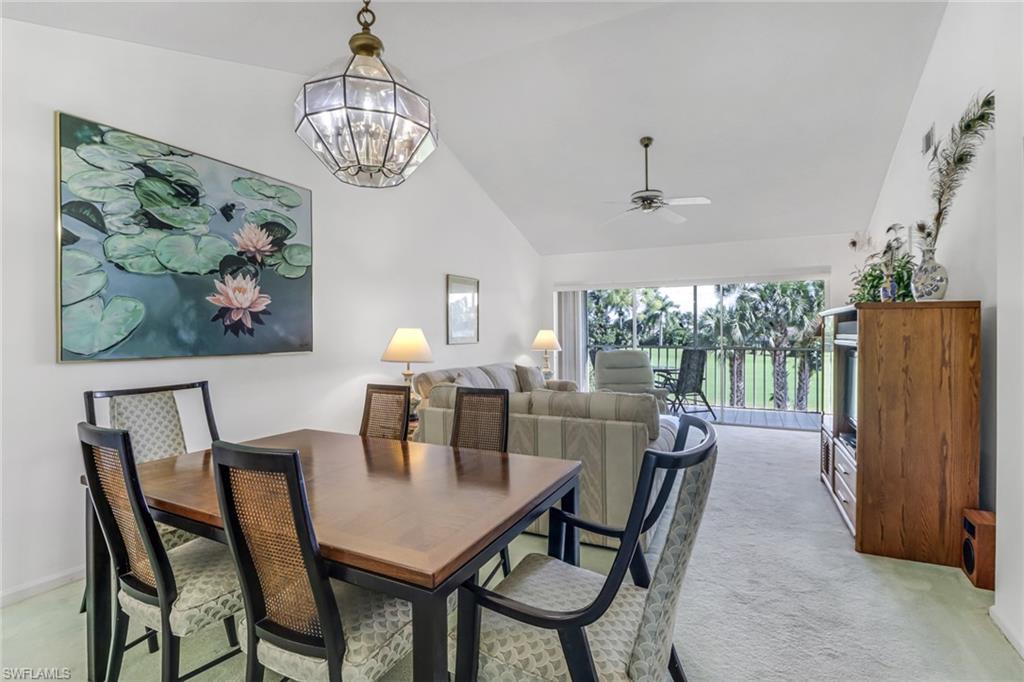 780 Augusta Boulevard, Unit C204 Naples, FL 34113 - Photo 12 of 40 a dining room with furniture a window and a chandelier
