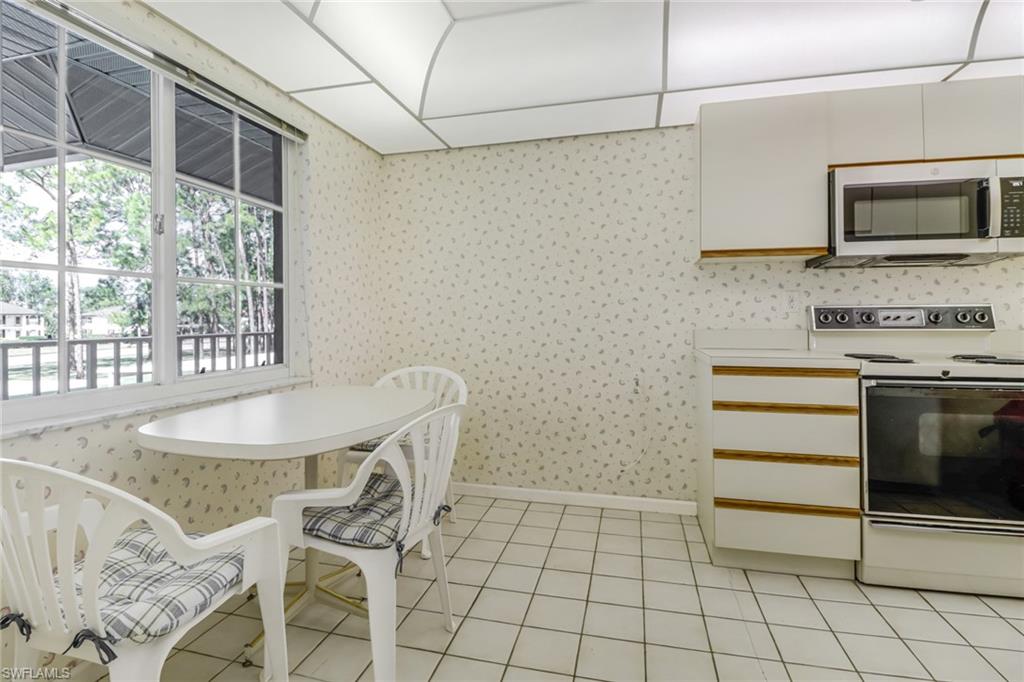 780 Augusta Boulevard, Unit C204 Naples, FL 34113 - Photo 13 of 40 a kitchen with a sink cabinets and appliances