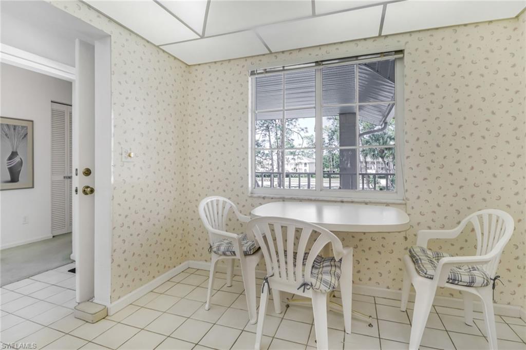 780 Augusta Boulevard, Unit C204 Naples, FL 34113 - Photo 16 of 40 a dining room with furniture and window