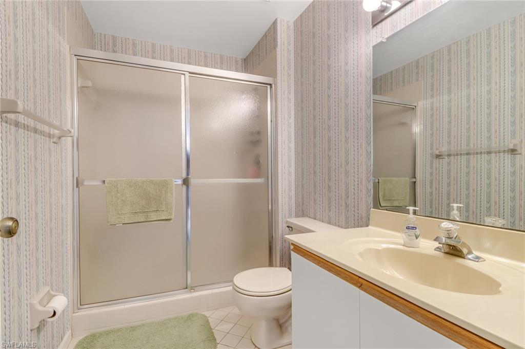 780 Augusta Boulevard, Unit C204 Naples, FL 34113 - Photo 23 of 40 a bathroom with a sink toilet and shower