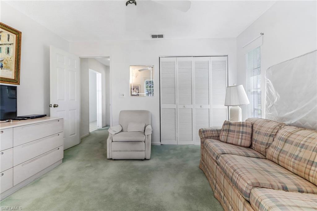 780 Augusta Boulevard, Unit C204 Naples, FL 34113 - Photo 24 of 40 a living room with furniture and a couch
