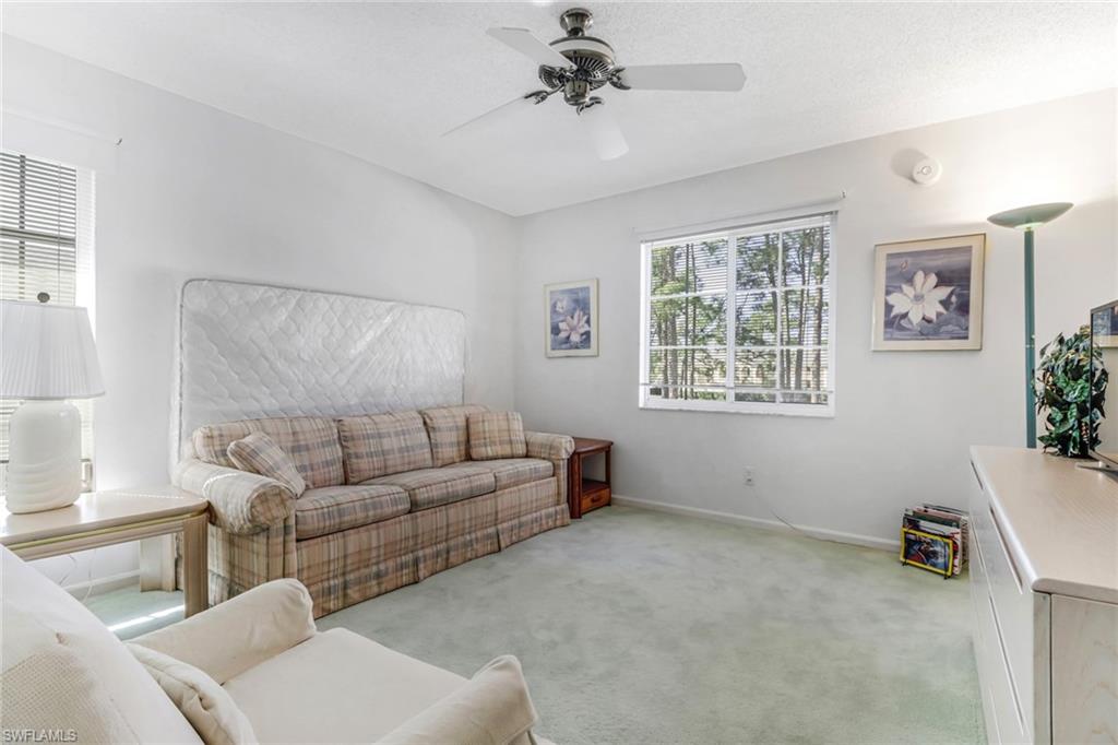780 Augusta Boulevard, Unit C204 Naples, FL 34113 - Photo 26 of 40 a living room with furniture and a window