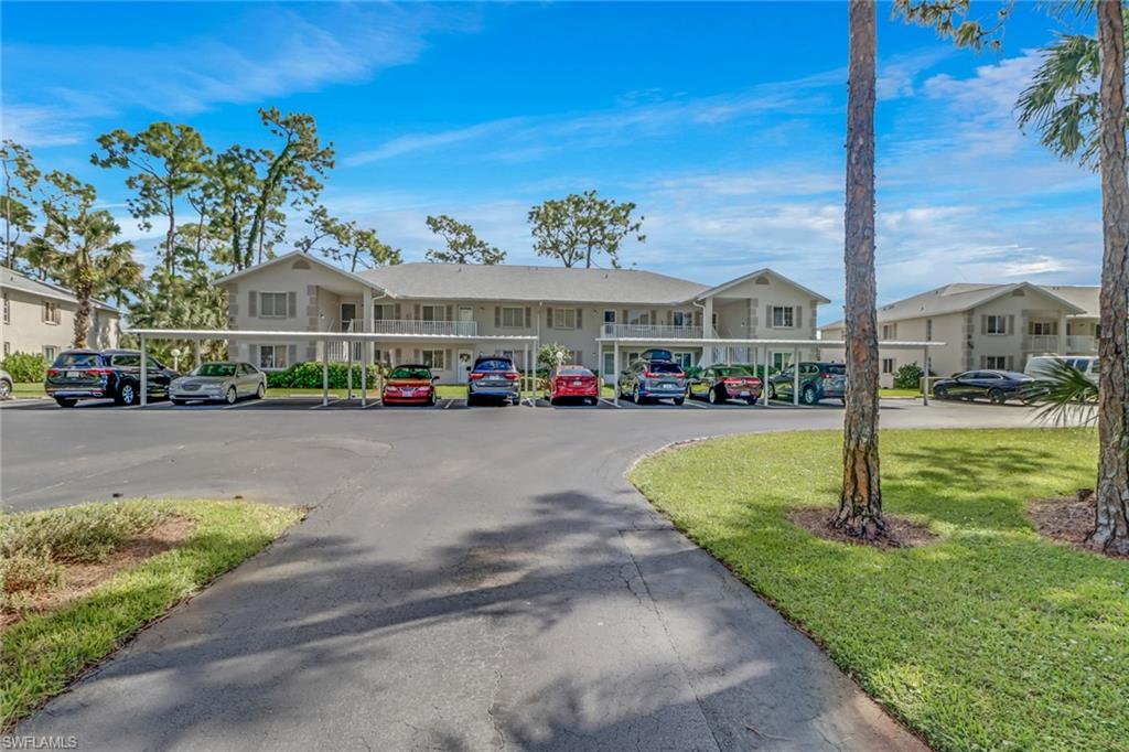 780 Augusta Boulevard, Unit C204 Naples, FL 34113 - Photo 3 of 40 a front view of building with yard