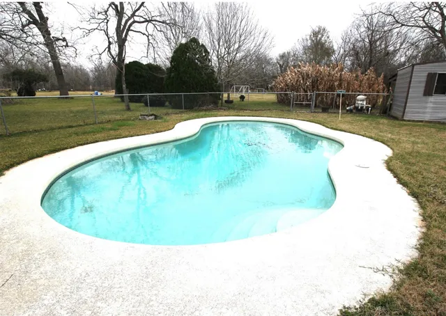 a view of a swimming pool with yard