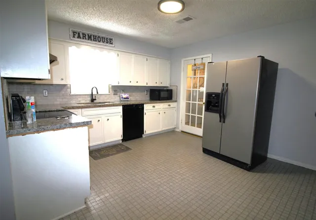 a kitchen with a refrigerator sink and stove