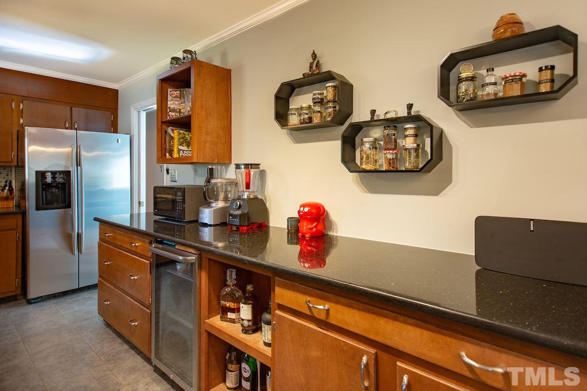 5300 Newhall Road Durham, NC 27713 - Photo 8 of 30 a kitchen with stainless steel appliances granite countertop a refrigerator and a stove