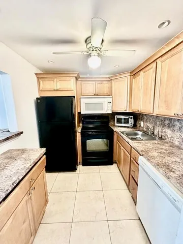 a kitchen with a stove a sink and a refrigerator