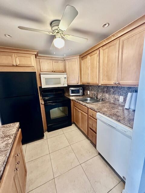 147 Fanshaw D Boca Raton, FL 33434 - Photo 4 of 27 a kitchen with a stove a sink and a microwave