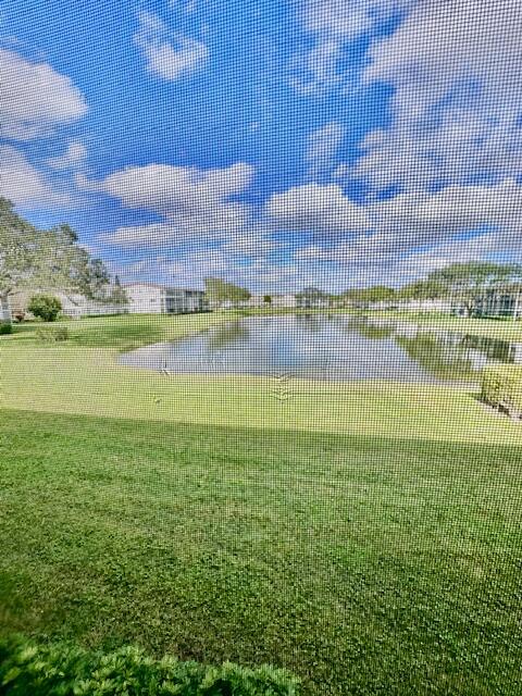 147 Fanshaw D Boca Raton, FL 33434 - Photo 8 of 27 a view of a lake with a building in the background