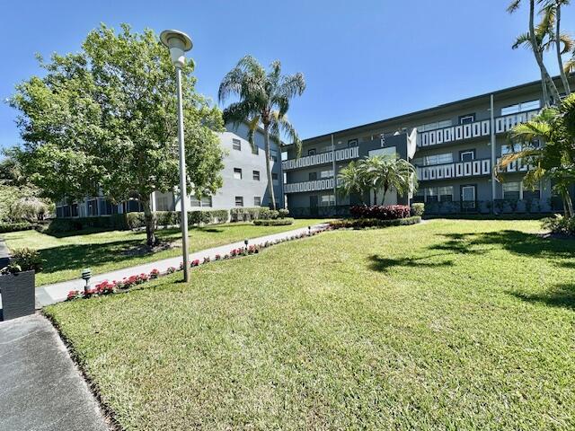 147 Fanshaw D Boca Raton, FL 33434 - Photo 10 of 27 a view of a house with a yard and plants