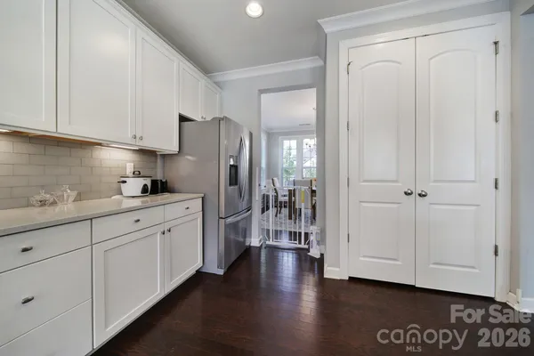 a kitchen with stainless steel appliances granite countertop a sink a stove and a wooden floors