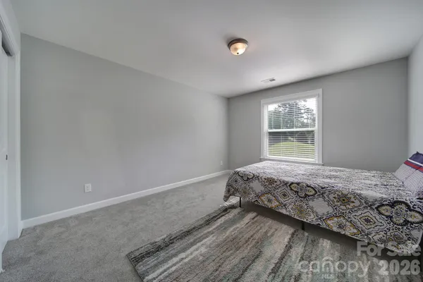 a bedroom with a bed and a closet