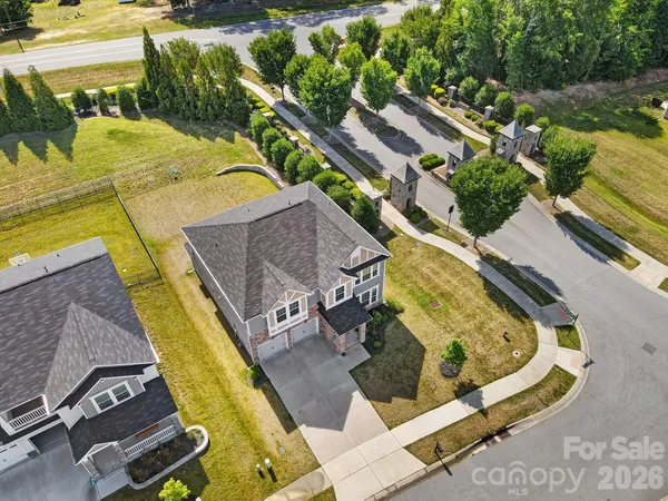 an aerial view of a house with a yard