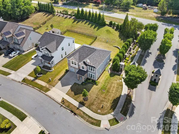 an aerial view of a house with garden space and street view