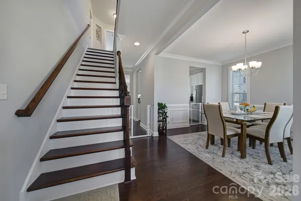 a view of a dining room with furniture and wooden floor