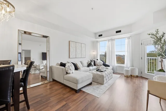 a living room with furniture or wooden floor and a large window