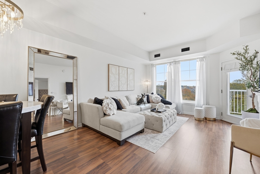 a living room with furniture or wooden floor and a large window