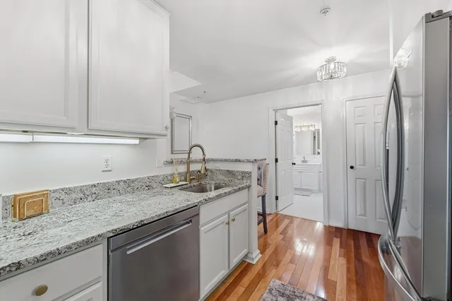 a spacious bathroom with a granite countertop sink a mirror and shower