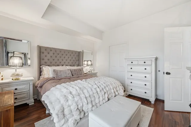 a bedroom with a bed and a dresser