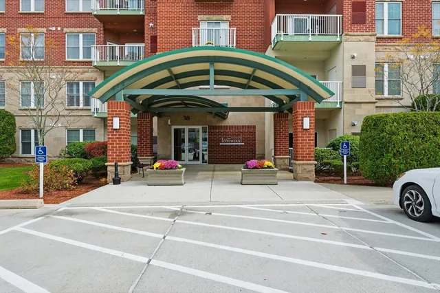 a view of a brick building with a small yard