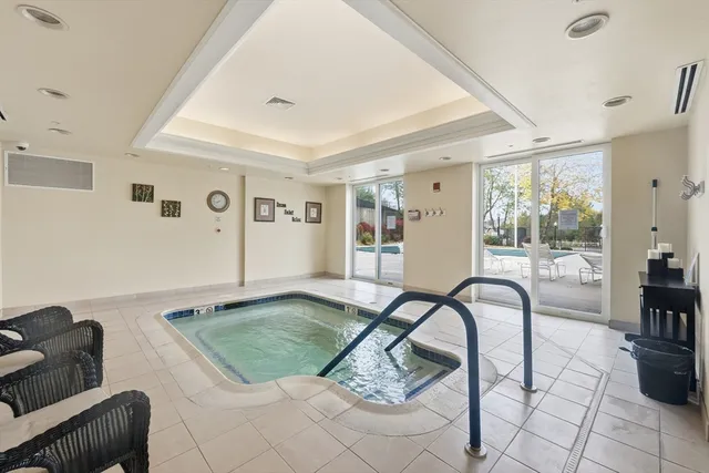 a living room with patio furniture and a large window