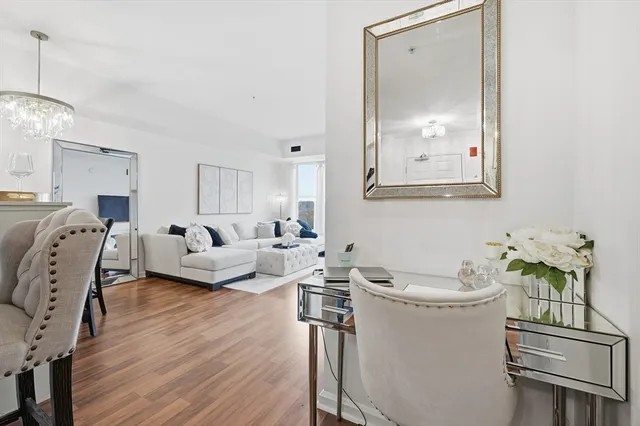 a living room with furniture a window and wooden floor