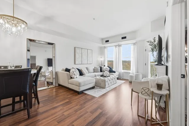 a living room with furniture dining area and wooden floor