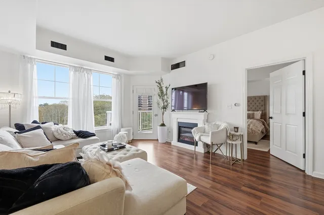 a living room with furniture flat screen tv and a fireplace