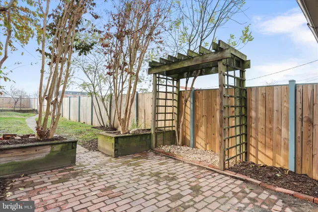 an empty room with a window and a ceiling fan