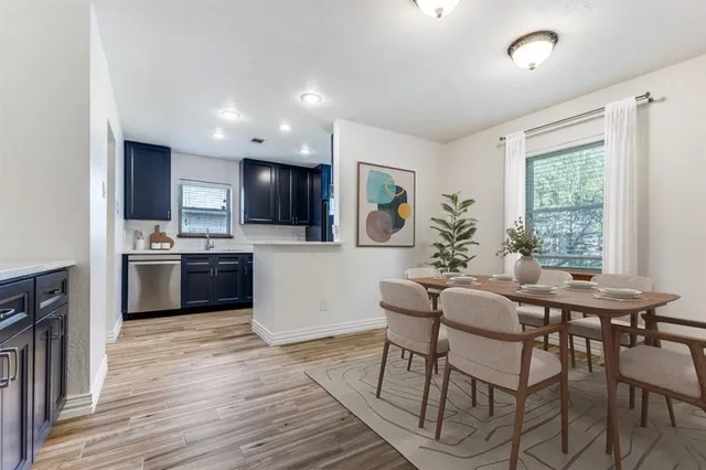 a view of a dining room with furniture and wooden floor