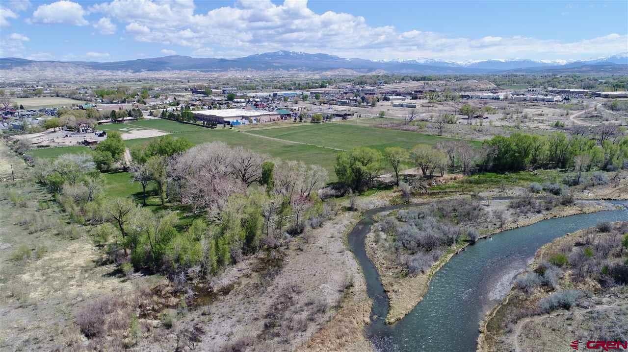 Tbd Tbd Montrose, CO 81401 - Photo 5 of 15 a view of a lake with green field