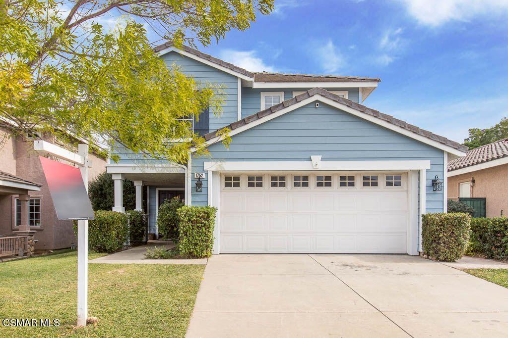 a front view of a house with a garden and plants